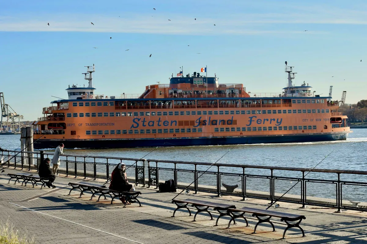 The Staten Island Ferry passing the waterfront promenade on a clear day